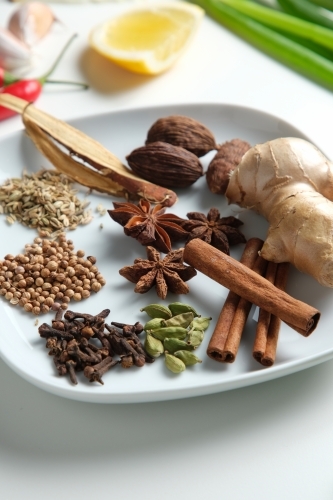Spices and herbs on white table - Australian Stock Image