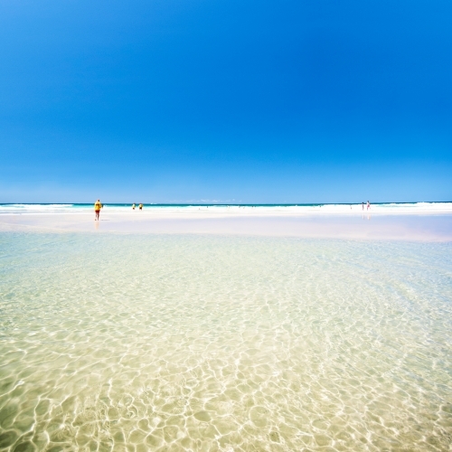 Square image of clear ocean waters with the lifesaver in the distance. - Australian Stock Image