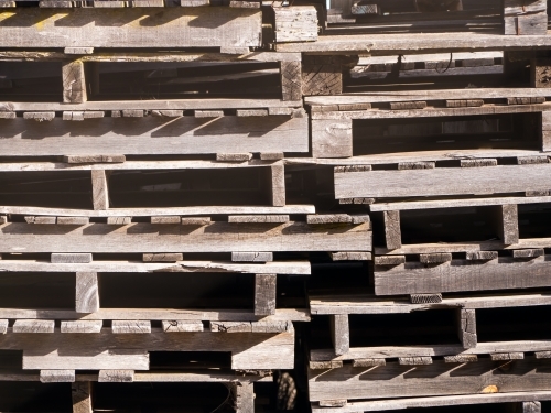 Stack of weathered old wooden pallets