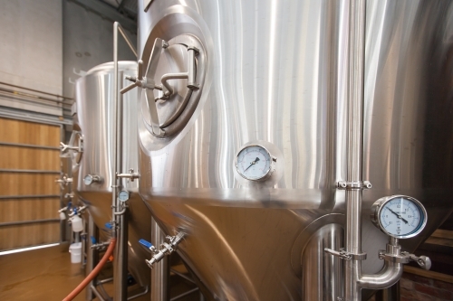 Stainless steel tanks and gauges at a microbrewery - Australian Stock Image