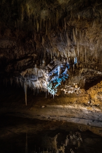Stalactites reflected in water in Lake Cave, Western Australia - Australian Stock Image