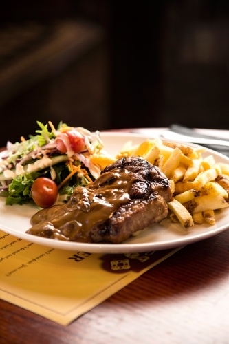 Steak and chips meal at pub - Australian Stock Image