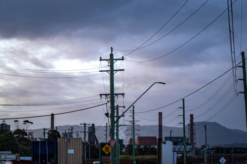 Steel Smelter behind power lines and poles - Australian Stock Image