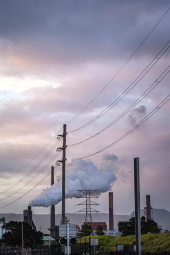 Steel Smelter behind power lines and power pole - Australian Stock Image