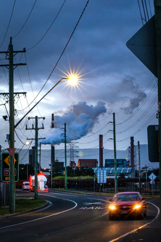 Steel Smelter factory behind power lines and road - Australian Stock Image