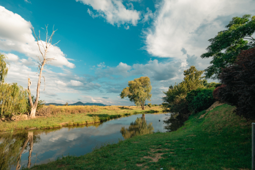 Still creek running through tranquil rural Australian setting - Australian Stock Image
