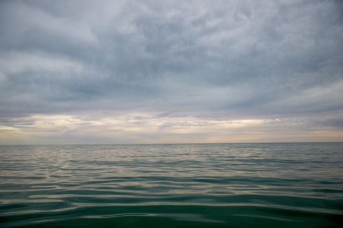 Still water beneath a brooding sky at dusk - Australian Stock Image