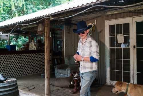 Stockman on Verandah of Farmhouse - Australian Stock Image