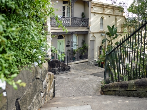 Stone stairs down to old urban homes - Australian Stock Image