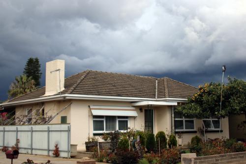 Storm brewing above suburban house