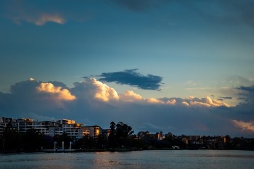 Storm clouds above riverside suburb - Australian Stock Image