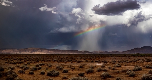 Storm clouds and rainbow over Flinders Ranges - Australian Stock Image