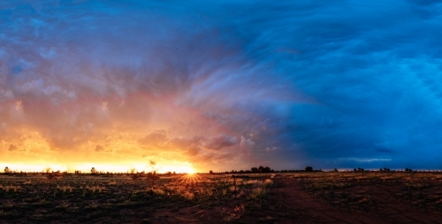 Storm clouds and sunset in a paddock