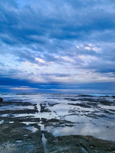 Storm clouds forming over the beach at Norah Head on the NSW Central Coast - Australian Stock Image
