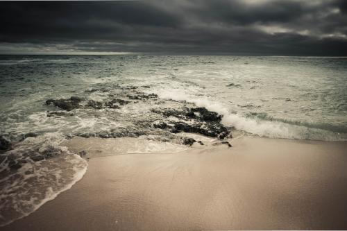 Storm clouds gathering over a pristine beach - Australian Stock Image