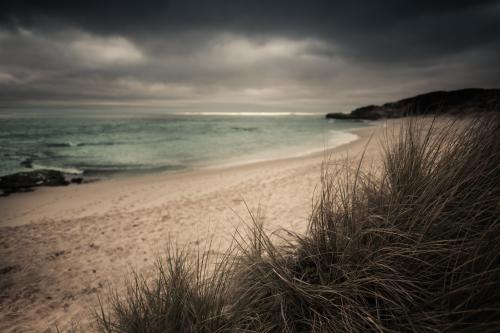 Storm clouds gathering over a pristine beach - Australian Stock Image