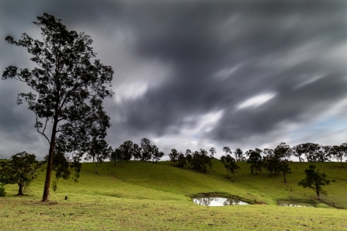 Storm clouds over farmland
