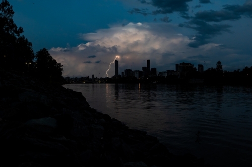 Storm clouds with lightning striking above Brisbane City. - Australian Stock Image
