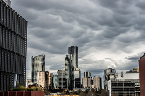 Storms over Melbourne CBD on a warm spring day in Melbourne - Australian Stock Image