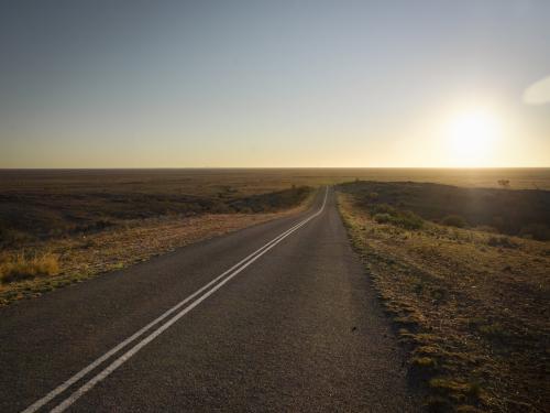 Straight road through open plain at Mundi Mundi Lookout - Australian Stock Image