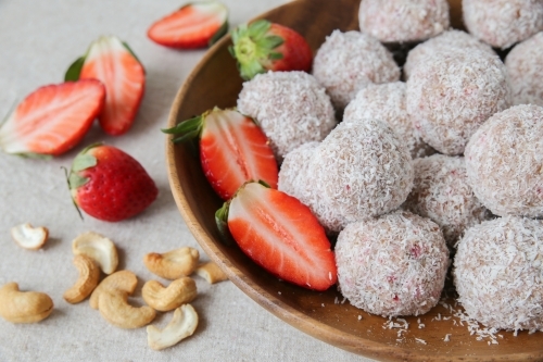 strawberry, date, cashew and coconut bliss ball - Australian Stock Image