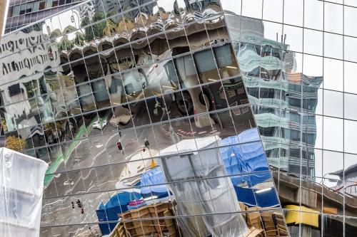Street and building site reflected in skyscraper - Australian Stock Image