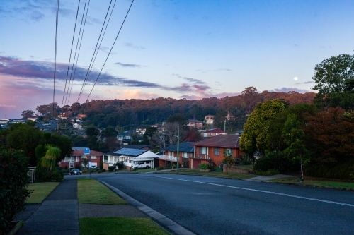 street at dusk with homes along roadside in suburb of Wallsend in Newcastle - Australian Stock Image