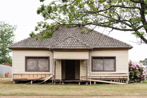 street view of regional suburban 60's style house in need of repair - Australian Stock Image