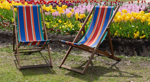 Striped brightly coloured outdoor deck chairs with tulips and hyacinths at Floriade Festival - Australian Stock Image