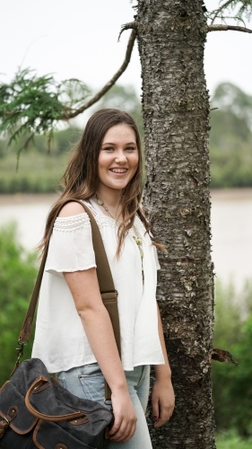 Student with bag in park - Australian Stock Image