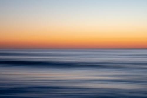 Stunning sunrise over calm ocean - Australian Stock Image