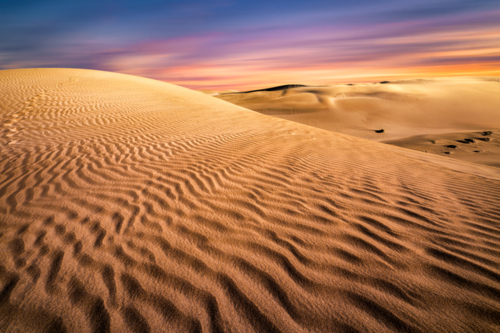 Stunning sunset over a sand dune - Australian Stock Image