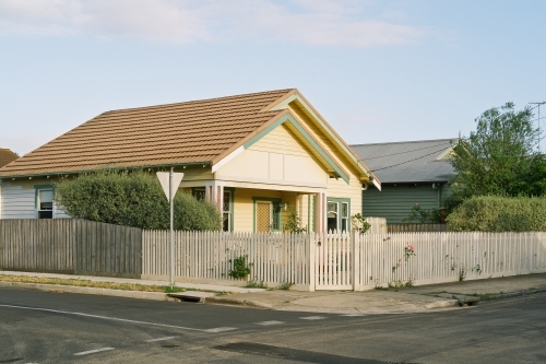Suburban street corner view of cream house - Australian Stock Image
