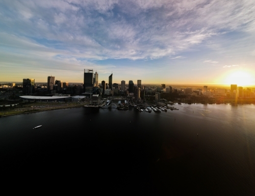Sun almost set behind Swan River and Perth city skyline