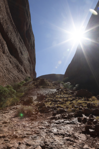 Sun flare between cliffs - Australian Stock Image