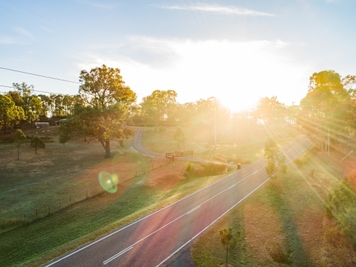 Sun flare over rural road - Australian Stock Image
