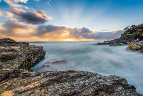 Sun rising over choppy ocean waters - Australian Stock Image