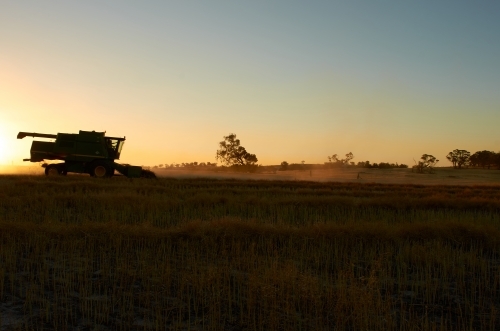 Sun setting on a combine harvester