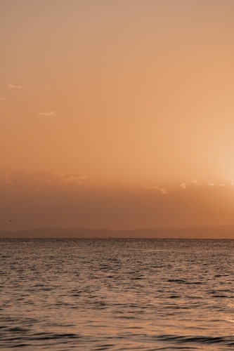 Sun setting over the water at Moreton Bay - Australian Stock Image