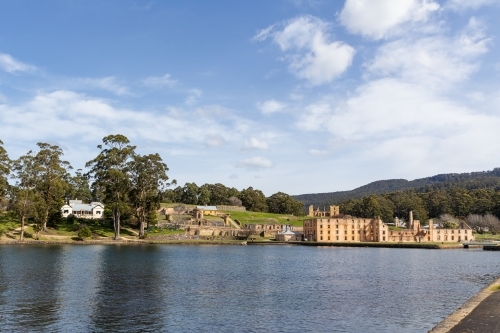 Sun shining brightly over the Penitentiary ruins on the far side of the lake. - Australian Stock Image