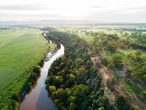 Sunflare light over cliff and Hunter River landscape near Singleton - Australian Stock Image