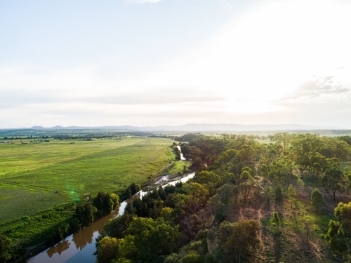Sunflare light over cliff and Hunter River landscape near Singleton - Australian Stock Image