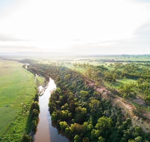 Sunflare light over cliff and Hunter River landscape near Singleton - Australian Stock Image