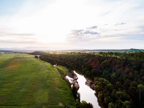 Sunflare light over cliff and Hunter River landscape near Singleton - Australian Stock Image