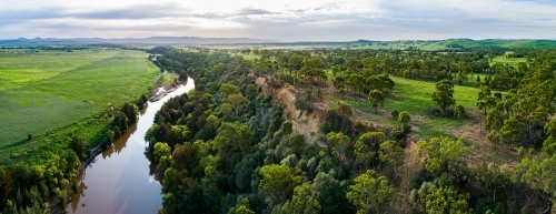 Sunflare light over cliff and Hunter River landscape near Singleton - Australian Stock Image