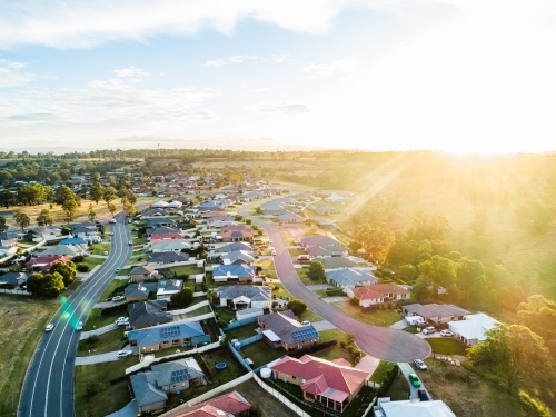 Sunflare of golden light over home owners properties in wealthy part of town - Australian Stock Image