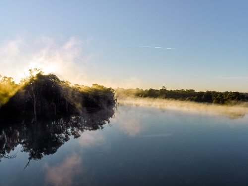 Sunrise and mist on river in the country - Australian Stock Image