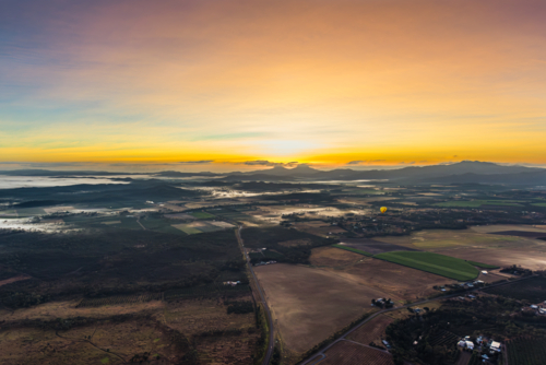 Sunrise hot air balloon ride over Mareeba in the Atherton Tablelands - Australian Stock Image