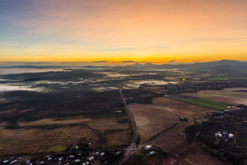 Sunrise hot air balloon ride over Mareeba in the Atherton Tablelands - Australian Stock Image