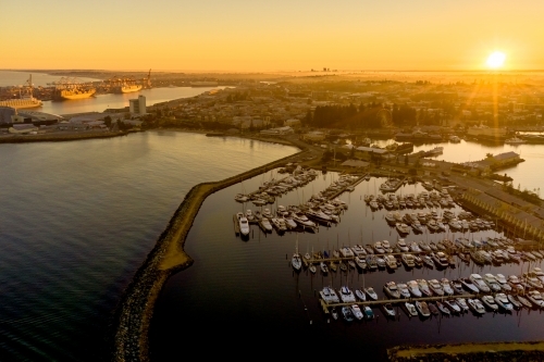 Sunrise on the horizon over Fremantle's challenger harbour marina, city & port in Western Australia - Australian Stock Image